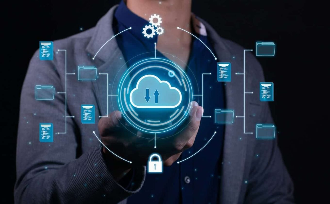 A man employs cloud-based computing on his smartphone to facilitate data transmission and backup.