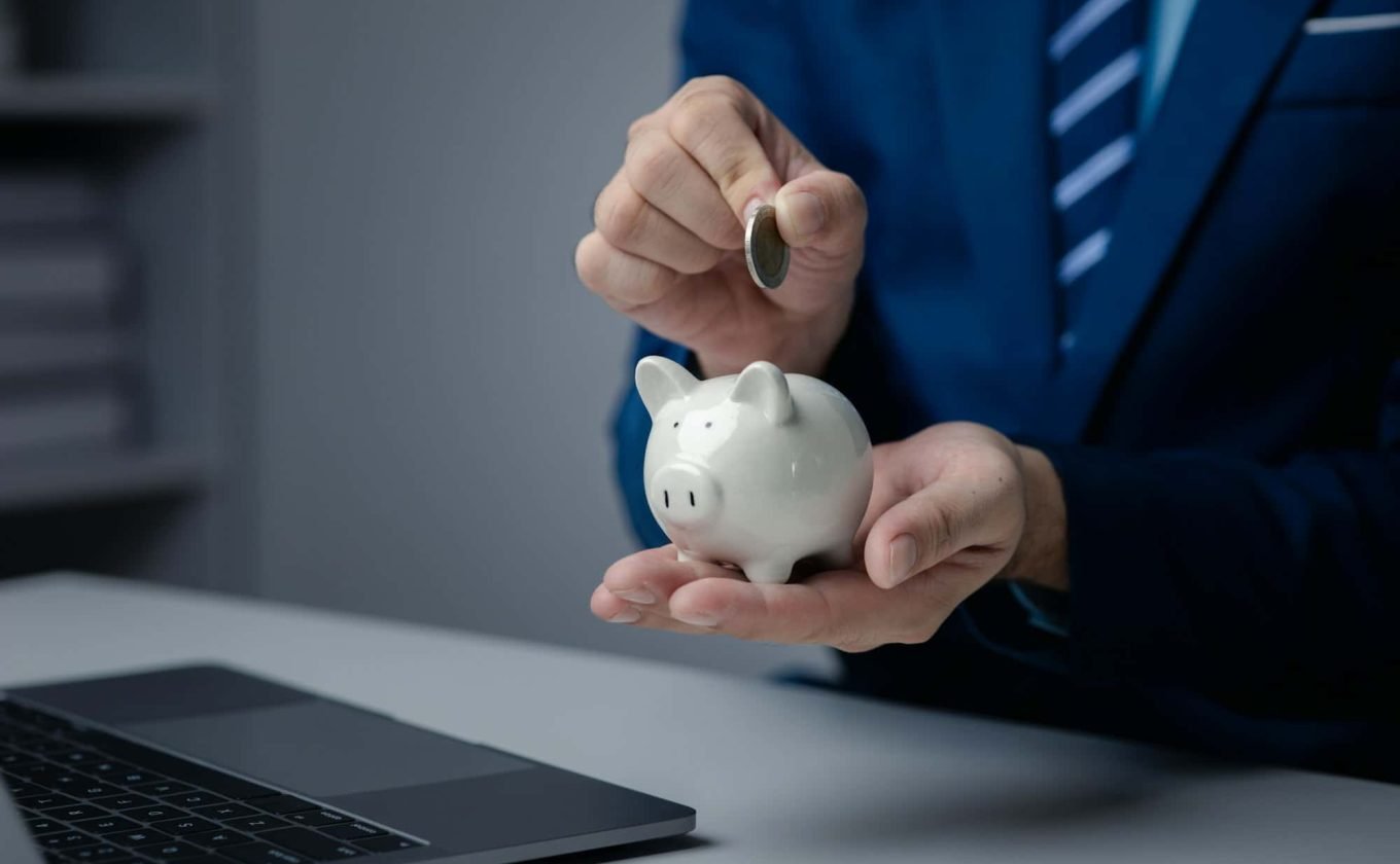 A person is holding a piggy bank, saving money and managing personal finances. Concept of increasing
