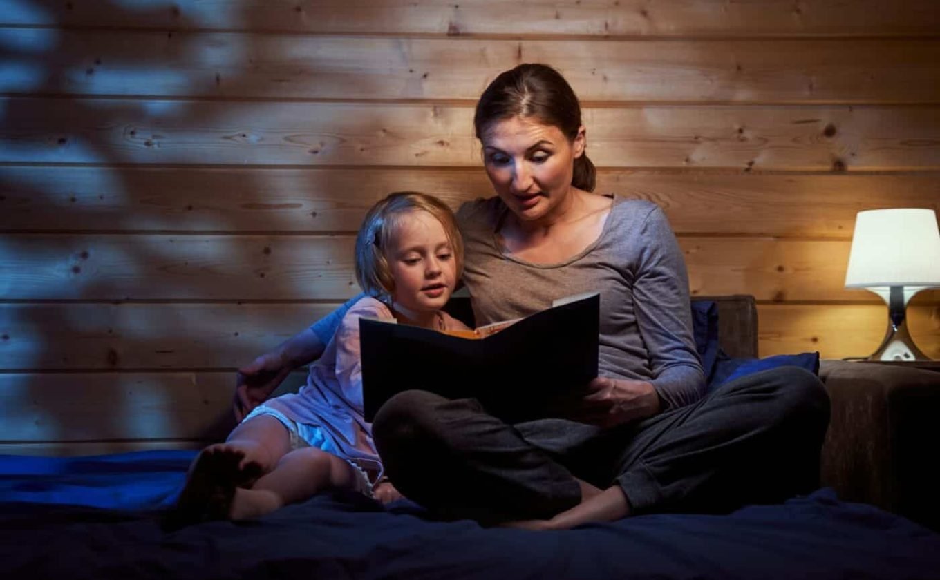 Mother reading bedtime stories to her child