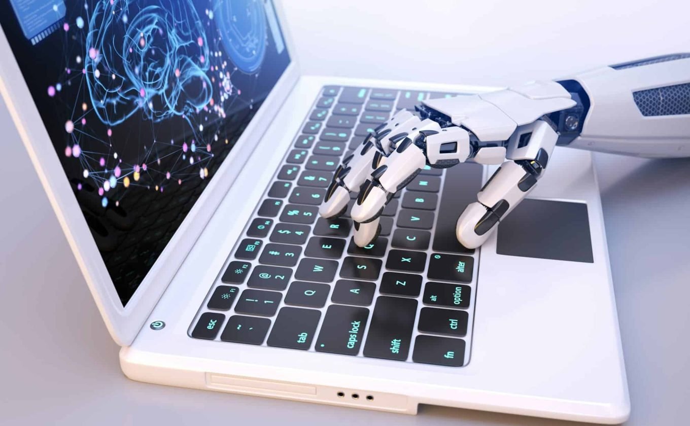Robot's hand typing on keyboard